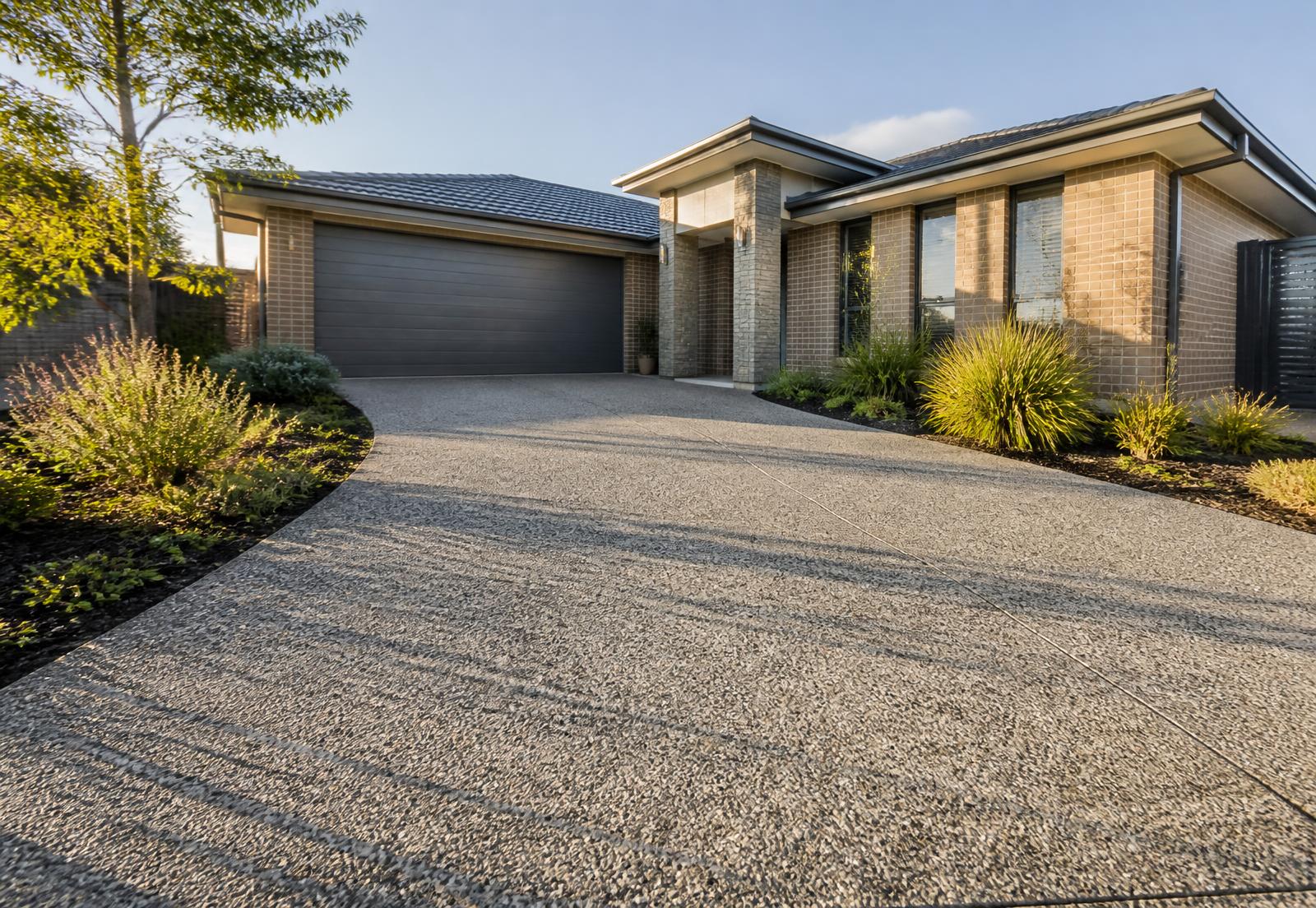 Newly finished exposed aggregate concrete driveway at a modern Australian home
